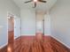 Main bedroom with hardwood floors and an open doorway to the en-suite bath at 3713 Becontree Pl, Oviedo, FL 32765