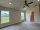 A spacious bedroom offers dual windows showcasing outdoor views, and an ensuite bathroom at 3891 Sagefield Dr, Harmony, FL 34773