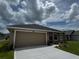 A well-maintained single Gathering house with an attached two car garage and lush green lawn at 3891 Sagefield Dr, Harmony, FL 34773