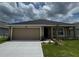 Charming single-story home with a two-car garage and well-maintained landscaping at 3891 Sagefield Dr, Harmony, FL 34773