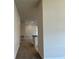 Hallway leading to an open-concept living space, showcasing modern finishes and ample lighting at 3891 Sagefield Dr, Harmony, FL 34773
