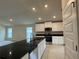 Modern kitchen with an island, stainless steel appliances, and plenty of cabinet space at 3891 Sagefield Dr, Harmony, FL 34773