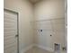 Bright laundry room featuring tile flooring and a wire rack for storage at 3891 Sagefield Dr, Harmony, FL 34773