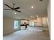 Open-concept living room and kitchen with modern appliances and a ceiling fan at 3891 Sagefield Dr, Harmony, FL 34773