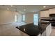 Open floor plan with views of the living area and stainless steel appliances at 3891 Sagefield Dr, Harmony, FL 34773
