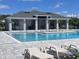 Relax by the pristine community pool featuring ample seating and a stylish shaded structure at 3891 Sagefield Dr, Harmony, FL 34773