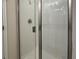 Sleek glass-enclosed shower with white tiled walls and contemporary fixtures at 3891 Sagefield Dr, Harmony, FL 34773