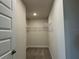 Walk-in closet with carpet flooring, shelving, and neutral walls at 3891 Sagefield Dr, Harmony, FL 34773