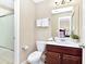 Clean and well-maintained bathroom with a sliding shower door and tiled floors at 4123 Oaktree Dr, Davenport, FL 33837