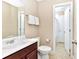 Well-lit bathroom featuring a vanity, toilet, and shower at 4123 Oaktree Dr, Davenport, FL 33837