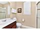 Well-maintained bathroom showcasing a dark wood vanity, framed mirror, and a shower with glass door at 4123 Oaktree Dr, Davenport, FL 33837