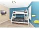 Bright bedroom with a fun bunk bed design and a mounted TV on the wall at 4123 Oaktree Dr, Davenport, FL 33837