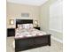 Neutral bedroom featuring tropical bedding, tile flooring, and ample natural light at 4123 Oaktree Dr, Davenport, FL 33837