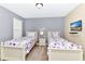 Colorful bedroom featuring twin beds, bright decor, and a large window for natural light at 4123 Oaktree Dr, Davenport, FL 33837