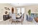 Charming dining area with a wood table for eight, flowing to a living space with stylish seating at 4123 Oaktree Dr, Davenport, FL 33837