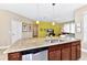Granite-topped kitchen island with stainless steel dishwasher and sink, in an open layout concept at 4123 Oaktree Dr, Davenport, FL 33837