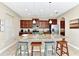 Spacious kitchen features granite counters, an island with seating, and modern stainless appliances at 4123 Oaktree Dr, Davenport, FL 33837