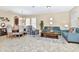 Open-concept living area with dining and living room, features neutral tile and comfortable seating arrangements at 4123 Oaktree Dr, Davenport, FL 33837