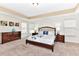 Spacious main bedroom with carpet, two windows, dresser, lamps and a tray ceiling at 4123 Oaktree Dr, Davenport, FL 33837