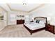 Bright main bedroom with a tray ceiling, carpet, and windows providing natural light at 4123 Oaktree Dr, Davenport, FL 33837