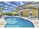 Enclosed pool area with an inviting swimming pool, lounge seating, and dining area at 4123 Oaktree Dr, Davenport, FL 33837