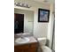 Standard bathroom with vanity, toilet and mirror featuring a wall decoration and recessed lighting at 4529 Alberto Cir, Kissimmee, FL 34746