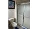 Standard bathroom with toilet and glass shower door. Neutral colors and nautical artwork at 4529 Alberto Cir, Kissimmee, FL 34746