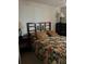 Bedroom featuring a bed with dark wood trim, matching nightstand, and chest of drawers at 4529 Alberto Cir, Kissimmee, FL 34746