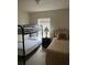 Bedroom with bunk beds and twin bed, showing window with blinds and bedside table with lamp at 4529 Alberto Cir, Kissimmee, FL 34746