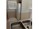 Kitchen corner featuring a double basin sink, tile flooring, and a window bringing in natural light at 4529 Alberto Cir, Kissimmee, FL 34746