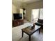 Cozy living space with access to outdoor patio space, a television, and stairs at 4529 Alberto Cir, Kissimmee, FL 34746