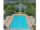 Aerial view of community pool and clubhouse surrounded by lush trees and well-manicured lawns at 4709 Fox St, Orlando, FL 32814