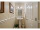 Elegant powder room featuring pedestal sink, decorative mirror, and neutral tones at 4709 Fox St, Orlando, FL 32814