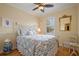Cozy bedroom with a white iron bed frame and a blue and white patterned comforter and shams at 4709 Fox St, Orlando, FL 32814