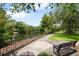 Picturesque park with benches along a scenic walkway by a calm lake, surrounded by lush greenery at 4709 Fox St, Orlando, FL 32814