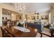 Spacious dining room with a chandelier, open floor plan and views into the living room at 4709 Fox St, Orlando, FL 32814