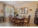 Refined dining room featuring a chandelier, seating for eight, and bright natural light at 4709 Fox St, Orlando, FL 32814