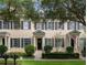 Charming townhome with neutral paint, black shutters, and mature trees in a lush community at 4709 Fox St, Orlando, FL 32814