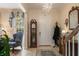 Elegant foyer with tile flooring, a crystal chandelier, grandfather clock, and staircase at 4709 Fox St, Orlando, FL 32814