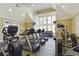 Well-equipped fitness center with treadmills, weights, and large windows for a bright workout space at 4709 Fox St, Orlando, FL 32814