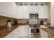 Bright kitchen boasts stainless appliances, granite counters, and ample cabinet space at 4709 Fox St, Orlando, FL 32814