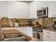 Kitchen featuring stainless steel appliances, granite countertops and stylish backsplash at 4709 Fox St, Orlando, FL 32814