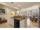 Open layout from kitchen view to dining room; stainless steel dishwasher and breakfast bar at 4709 Fox St, Orlando, FL 32814