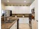 Well-lit kitchen features stainless steel appliances, white cabinetry, and stylish backsplash at 4709 Fox St, Orlando, FL 32814