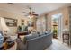 Relaxing living room with a plush sofa, shuttered doors leading to the outdoor patio at 4709 Fox St, Orlando, FL 32814