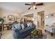 Bright living room showcasing a blue patterned sofa, chandelier and open floor plan to kitchen at 4709 Fox St, Orlando, FL 32814
