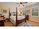 Comfortable bedroom featuring a four-poster bed, hardwood floors, and natural light from shuttered windows at 4709 Fox St, Orlando, FL 32814