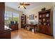 Home office with built-in shelving, desk, hardwood floors and natural light at 4709 Fox St, Orlando, FL 32814