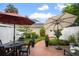 Charming brick patio with seating area, umbrellas, and manicured landscaping at 4709 Fox St, Orlando, FL 32814