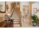 Bright staircase with beige walls, trimmed in white, complemented by decorative artwork at 4709 Fox St, Orlando, FL 32814